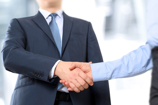 The Close-up image of a firm handshake between two colleagues in office. - Photo, Image