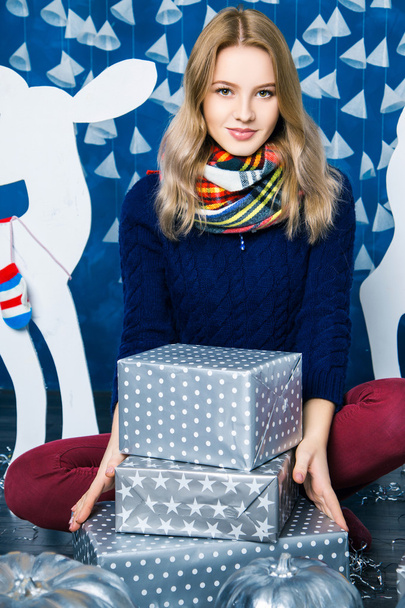 girl sitting in blue and white Christmas decorations - Valokuva, kuva