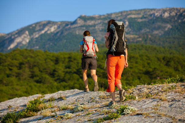Two women is trekking in the Crimea mountains with backpacks - Photo, Image