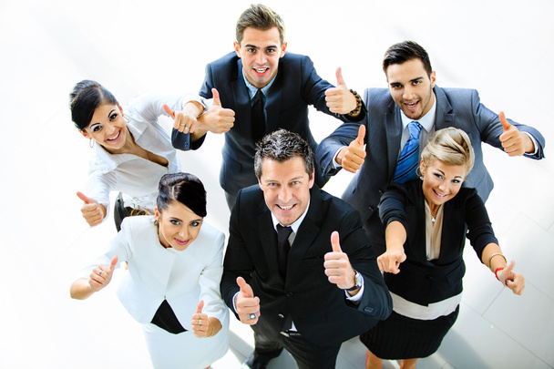 Top view of executives smiling and pointing - Foto, afbeelding