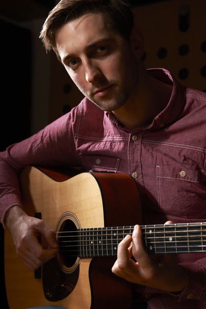 Man Playing Acoustic Guitar In Recording Studio - Фото, изображение