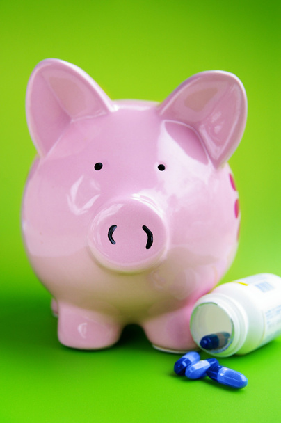 Piggy bank with pills - Фото, изображение