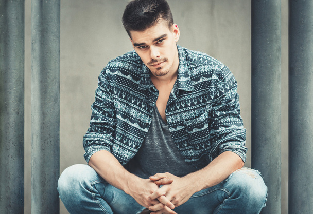 Young stylish man model posing near beton wall. Fashion shot - Fotografie, Obrázek