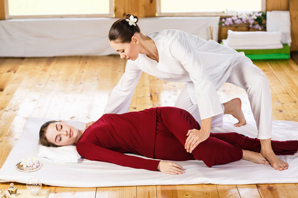 Woman getting thai stretching massage - Photo, Image