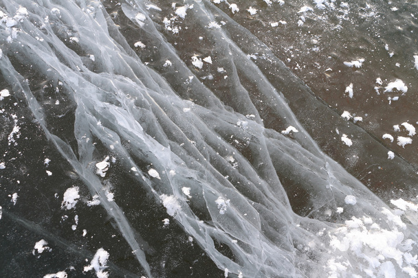 Cracks on an ice surface of the river, a natural background - Фото, изображение