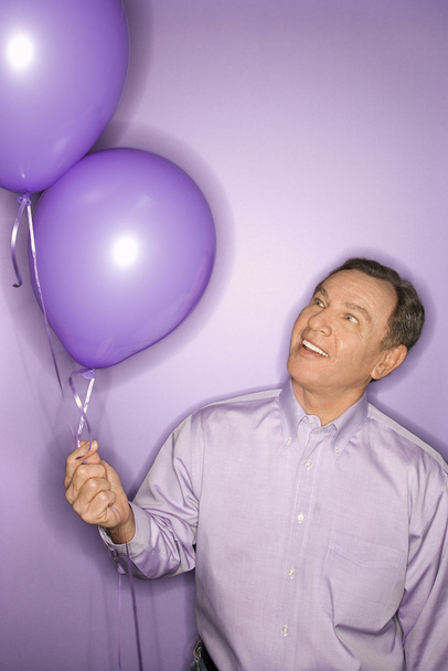 Man with balloons. - Foto, afbeelding