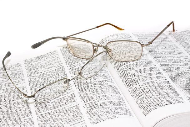 Closeup of opened book and glasses - Foto, Imagen