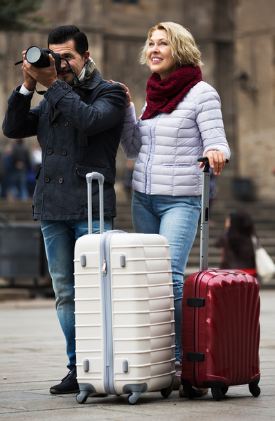 Mature couple walking with luggage - Foto, Imagen
