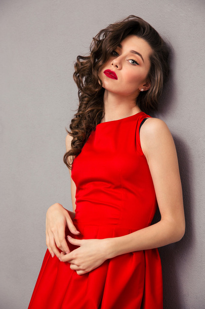 Attractive woman in red dress - Фото, изображение
