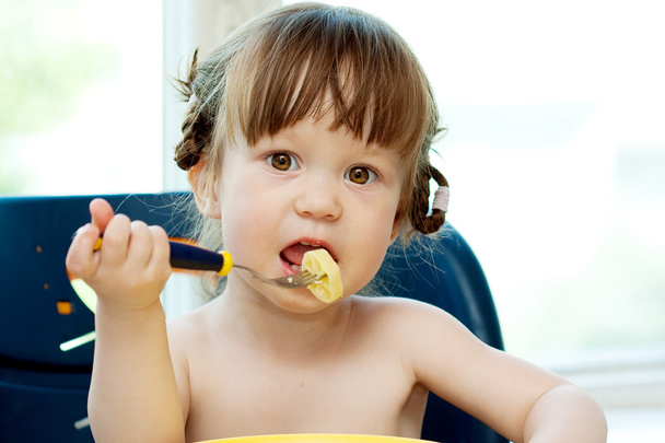 eating baby girl at home - Photo, Image