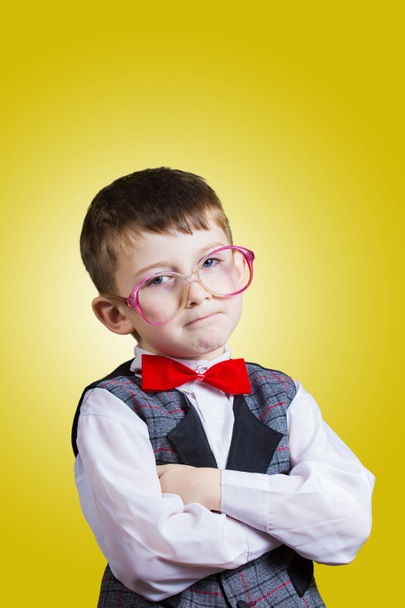 Confident little boy nerd isolated over yellow background. - Photo, Image