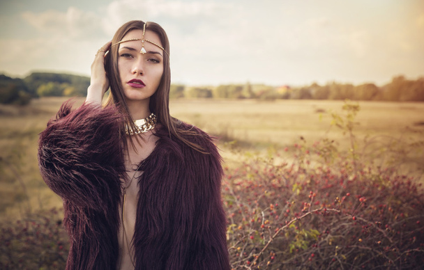 Girl in fur coat on background of beautiful field. Fashion - Fotó, kép