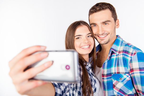 Closeup photo of a cheerful pretty couple in love making selfie - Photo, Image