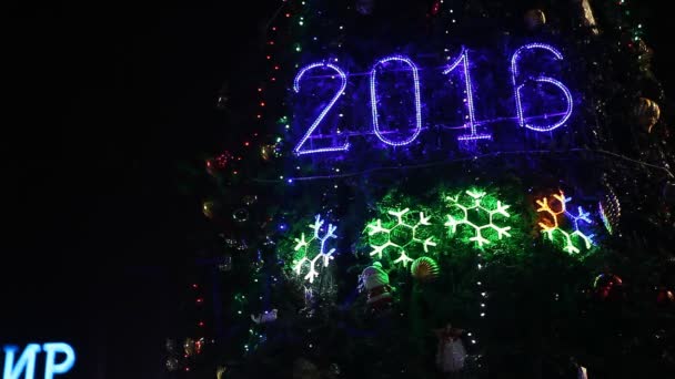 lit 2016 sign on illuminated Christmas tree - Footage, Video
