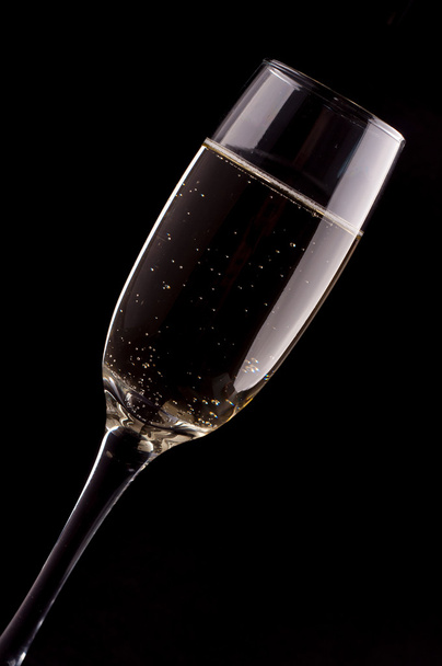 A glass of champagne on black background - Photo, Image