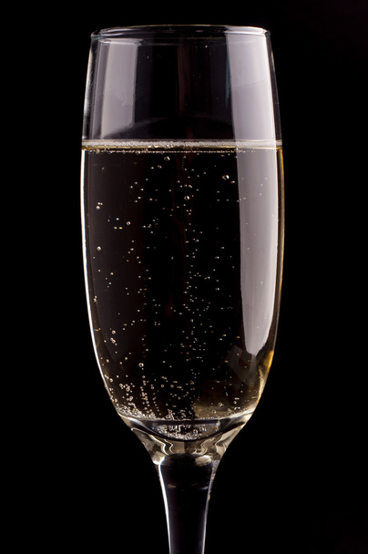 A glass of champagne on black background - Foto, Imagem