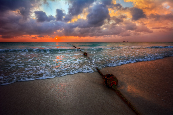 zonsondergang over een oceaan strand - Foto, afbeelding