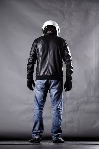motorist with a helmet, leather jacket and jeans - Фото, изображение