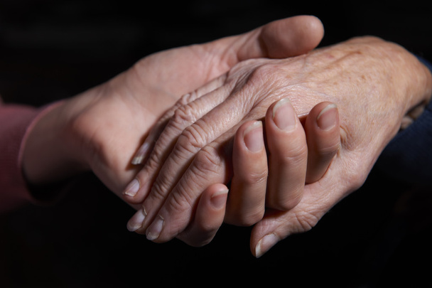 Young Woman Holding Older Woman's Hand - Foto, Bild