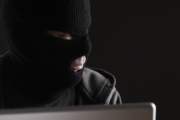Masked Criminal Accessing Computer Data - Fotografie, Obrázek