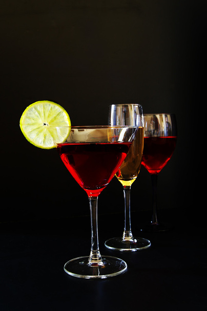 Champagne, wine, and martini glasses on dark background - Foto, Imagem