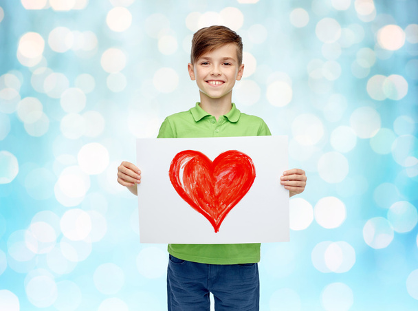 happy boy holding drawing or picture of red heart - Fotografie, Obrázek