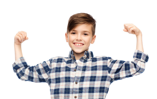 happy boy in checkered shirt showing strong fists - Фото, зображення