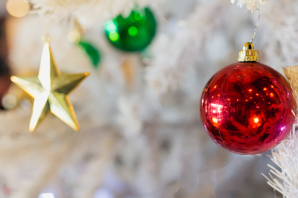 Golden star with red green ball and white Christmas tree backgro - Foto, imagen