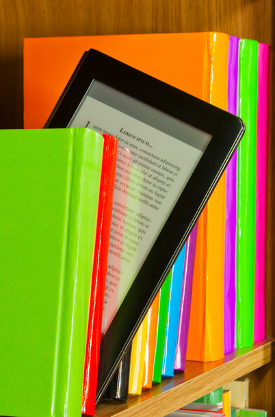 Row of colorful books and electronic book reader - Photo, Image