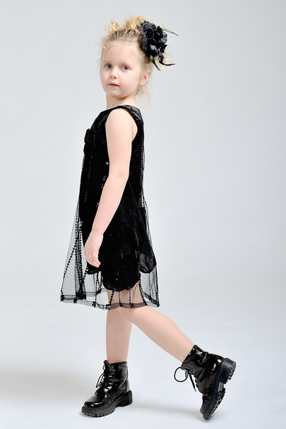Portrait of a little girl in a black dress - Fotó, kép