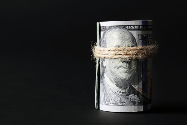 Dollars roll on black background - Photo, Image