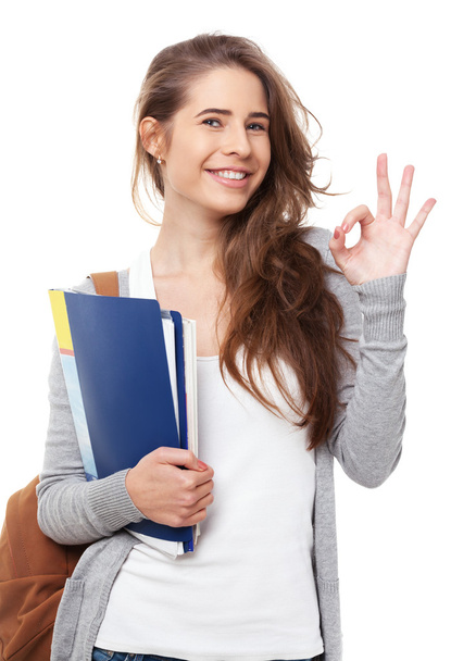 Young happy student showing ok sign isolated on white. - Foto, Imagem