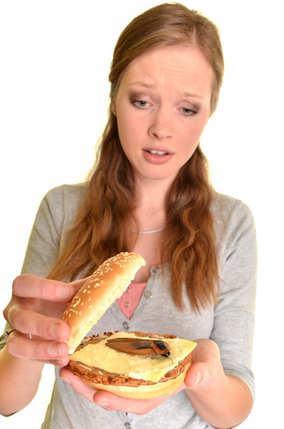 Surprised woman with burger with cockroach - Foto, Imagem