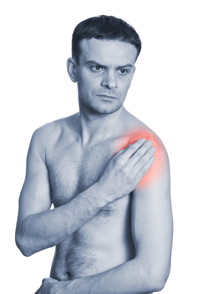 mladý muž, držící rameno s bolest - Fotografie, Obrázek