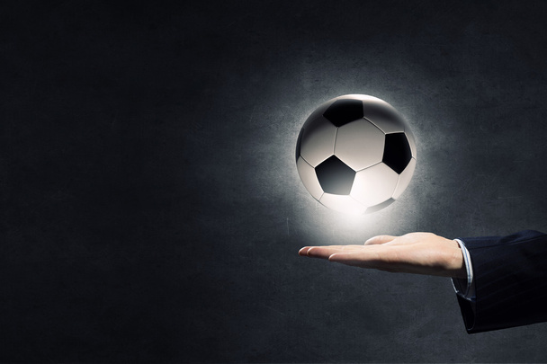 Soccer ball in palm - Фото, зображення