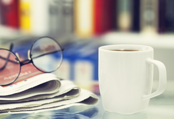 Cup of coffee and newspaper on table - Foto, Bild