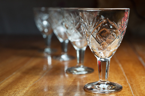 Several empty crystal glasses standing in a row - Photo, image