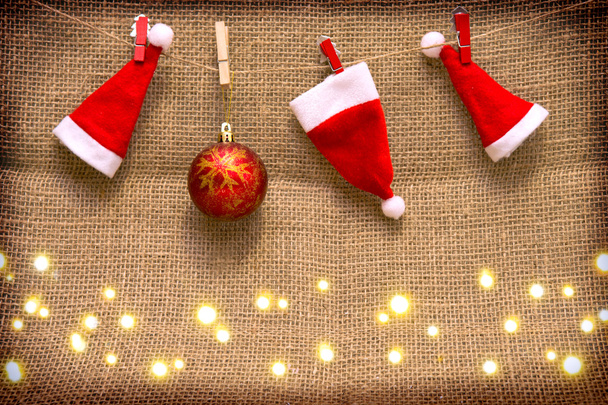 Três chapéus de Papai Noel e bola de Natal vermelho isolado
 . - Foto, Imagem