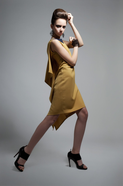 Fashionable girl in modern dress posing in studio - Photo, Image