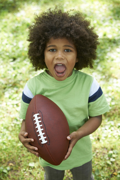 Excited Young Boy Playing American Football In Park - Foto, Imagen
