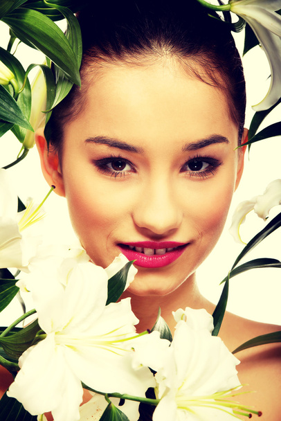 Beauty face of a woman with flowers. - Fotografie, Obrázek