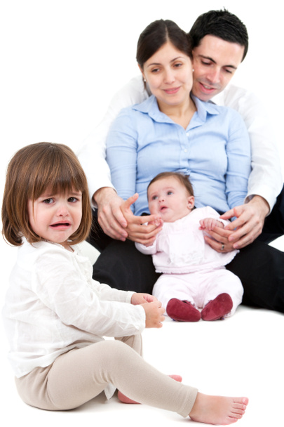 Unhappy jealous little girl with family - Photo, Image