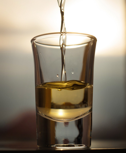 A shot of an alcohol beverage being drunk - Foto, Imagen