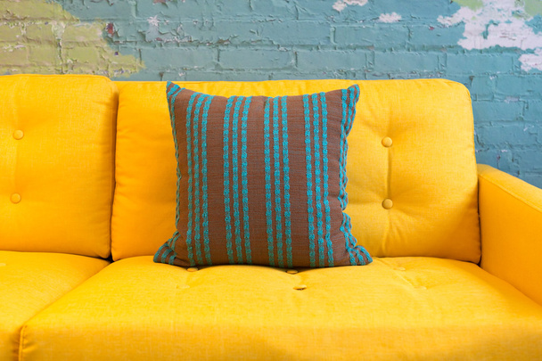 Close up of yellow fabric sofa and cushions - Fotografie, Obrázek