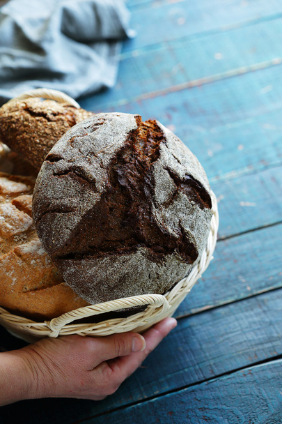 hand with basket full of breads - Foto, Imagen