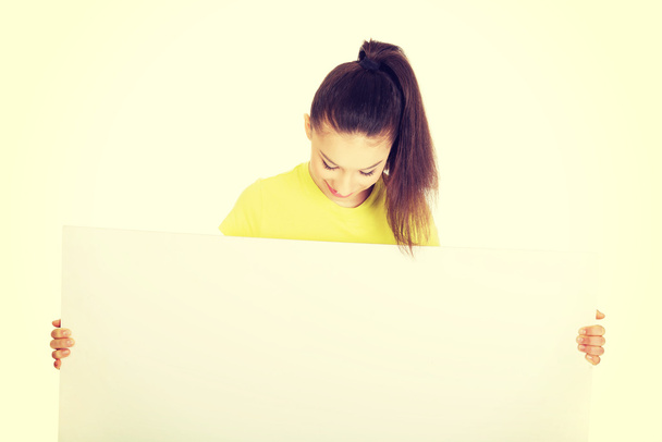 Young happy woman with blank board. - Foto, Bild