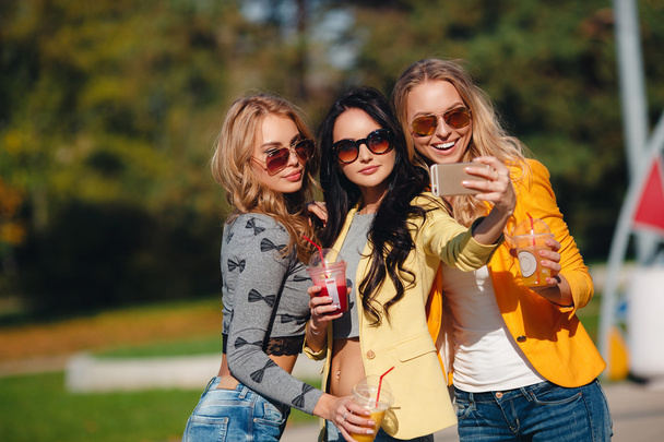 Three beautiful women take off their selfie on smartphone - Zdjęcie, obraz