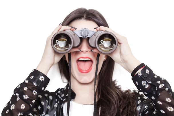 Girl portrait looking at coffee cup through binoculars - Foto, Imagem