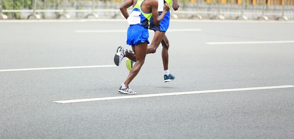 Marathon runners running on road - 写真・画像