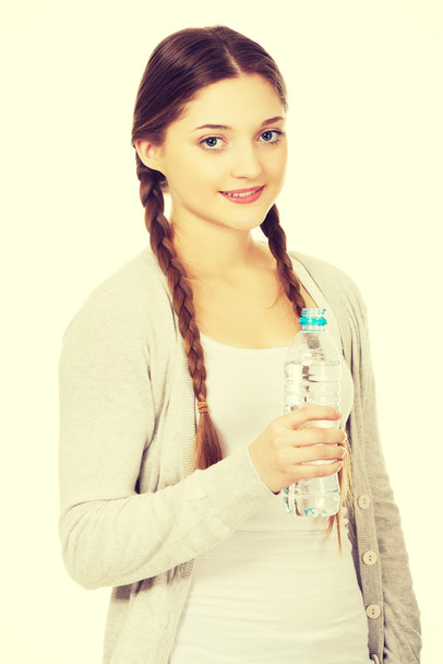 Beautiful woman with bottle of mineral water. - Fotografie, Obrázek